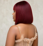 Woman wearing a deep red human hair blunt cut wig