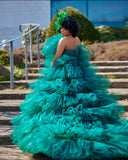 Emerald mermaid tiered tulle bridal gown with dramatic train and voluminous layers
