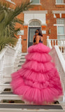 Fuchsia tiered tulle high-low skirt with dramatic train styled on staircase