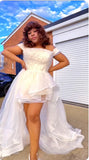 Person wearing a white high-low organza dress that is perfect for beach wedding 