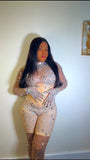Back view of nude illusion rhinestone bodysuit with fitted design and sheer mesh