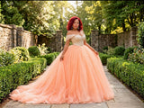 Front view of the St Zandas Aurelia gown with an ivory embellished off-shoulder bodice and voluminous peach tulle skirt
